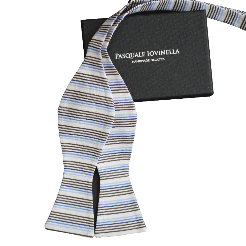 White bowtie with blue and brown vertical stripes (child)